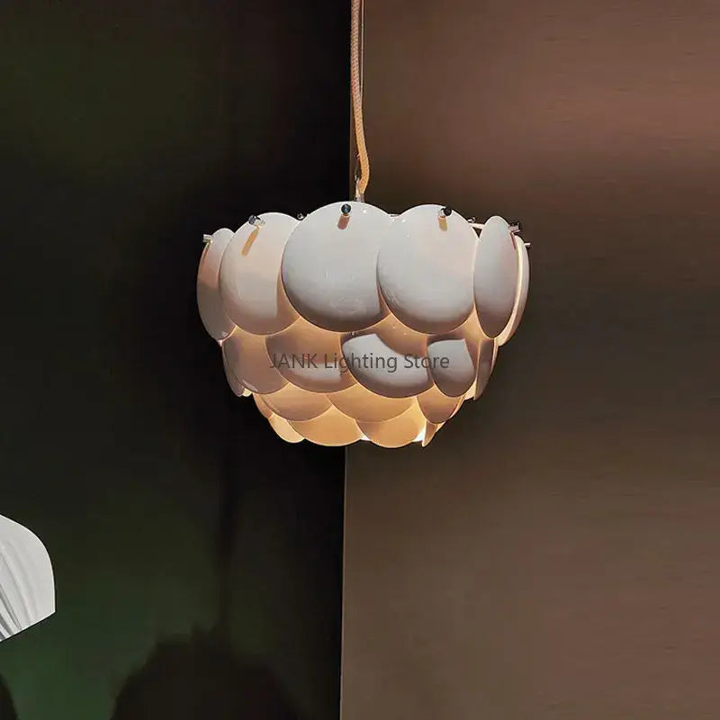 Modern white french ceramic chandelier pendant light with layered scalloped design and warm glowing illumination decorbites french ceramic