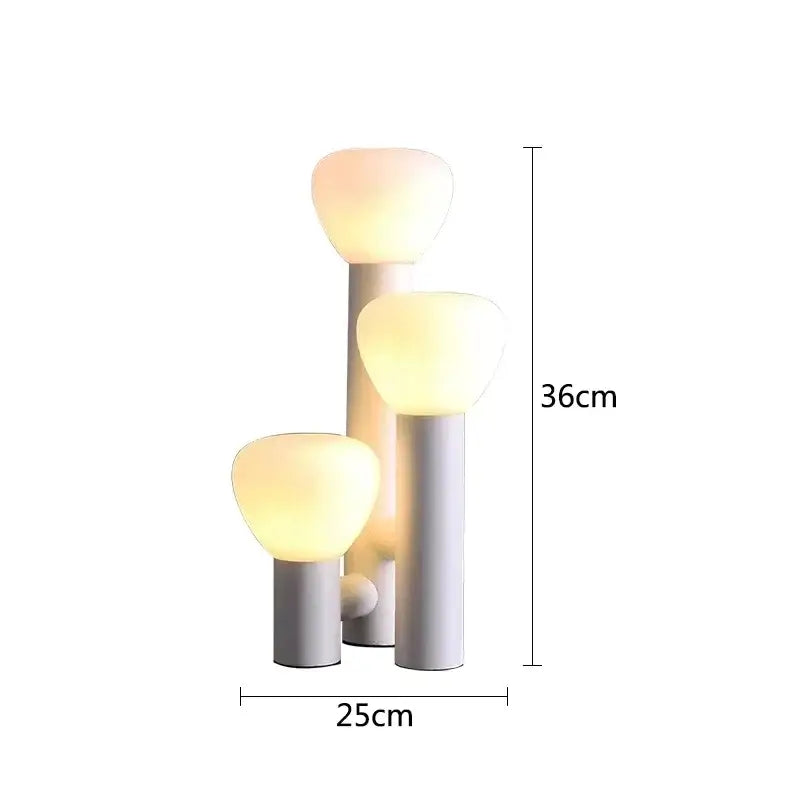 Modern white frosted glass table lamp with cylindrical base and softly glowing rounded shade for bedroom decorbites glass table lighting