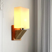 Modern warm-toned wall lamp with white frosted glass shade and wooden base with metal accents for bedroom use