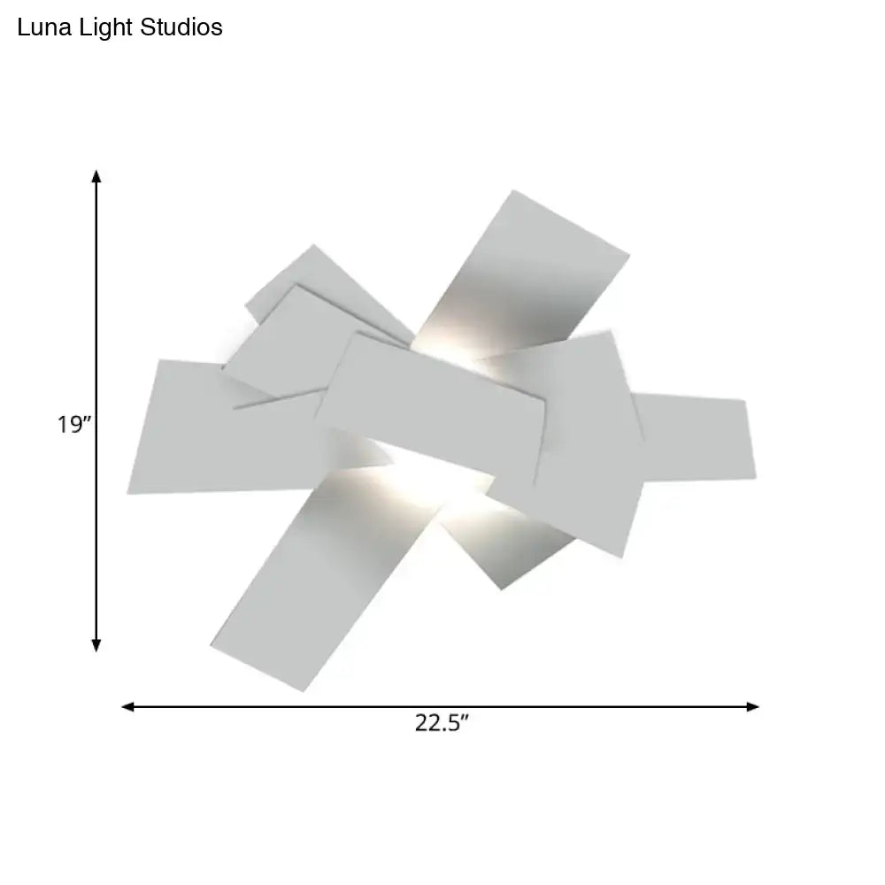 Modern white geometric wall sconce with angular overlapping panels featuring 110v-120v bulb base for bedroom use