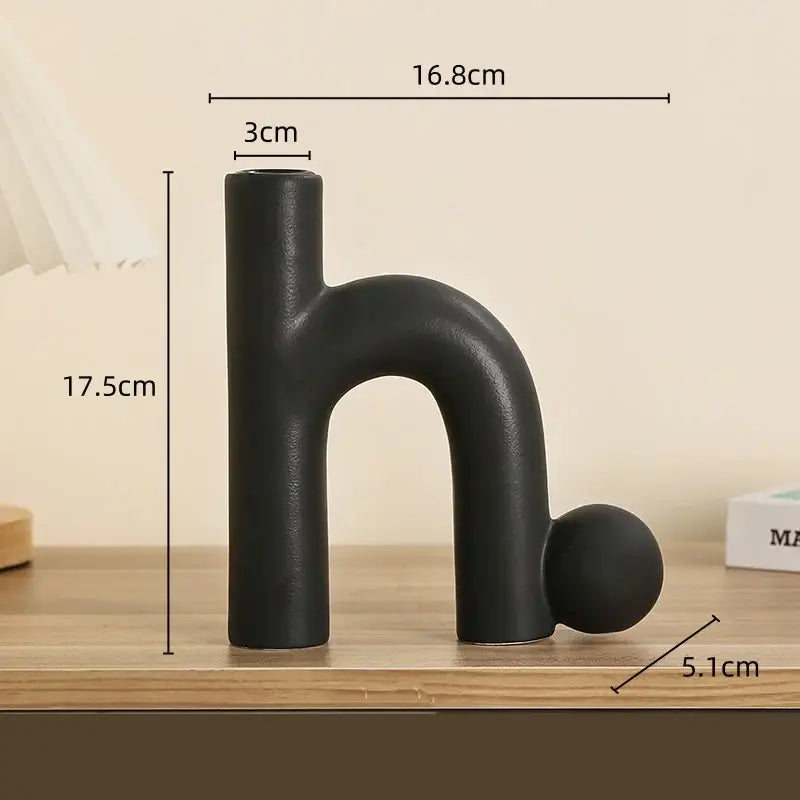 Black matte ceramic vase shaped like letter h with spherical base for decorbites geometric ceramic candle holders decor