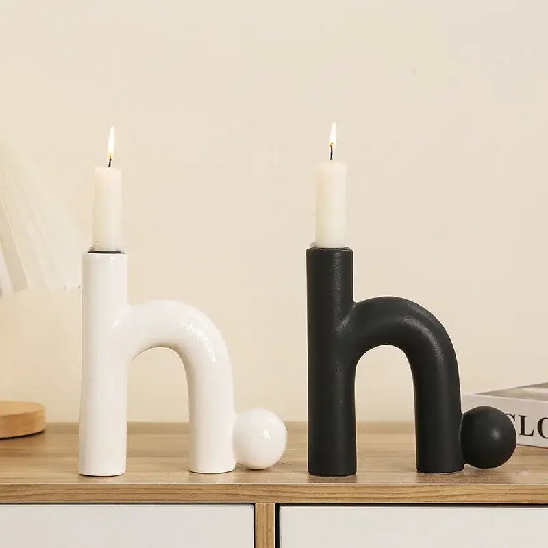 Modern white and black geometric ceramic candle holders shaped like letter h with lit white candles for living room decorbites geometric ceramic candle
