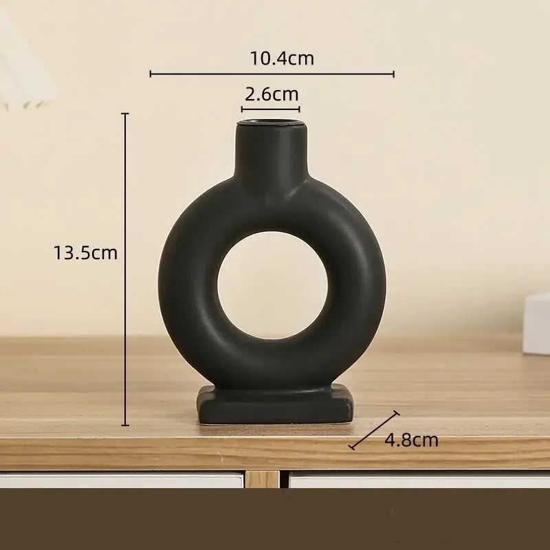 Black ceramic candle holder with circular ring design and square base in modern white geometric ceramic decorbites style