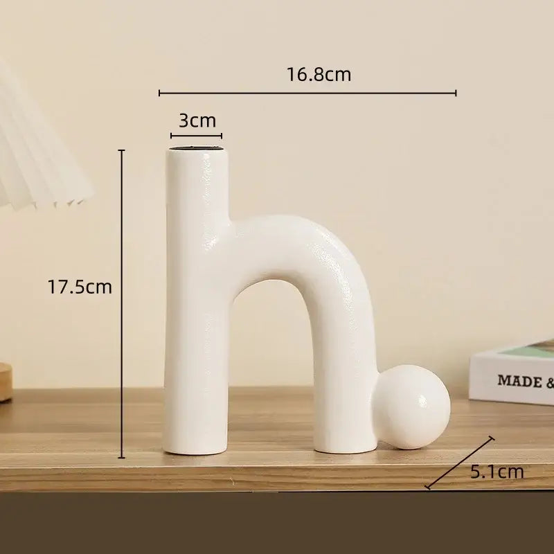 Modern white geometric ceramic candle holder with sleek abstract h shape and rounded base for living room decorbites decor
