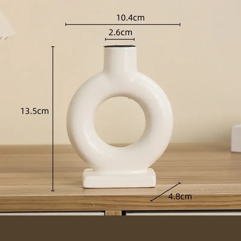 Modern white geometric ceramic candle holder with minimalist ring design and smooth glossy finish for living room decorbites