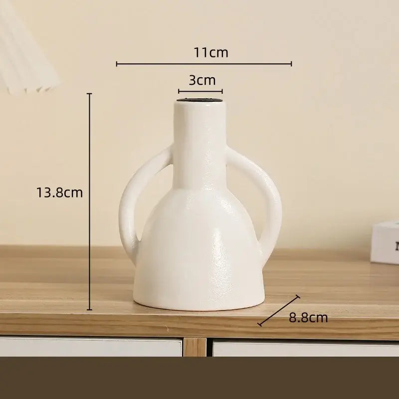 Modern white geometric ceramic candle holder with two curved handles and narrow neck for living room decorbites decor