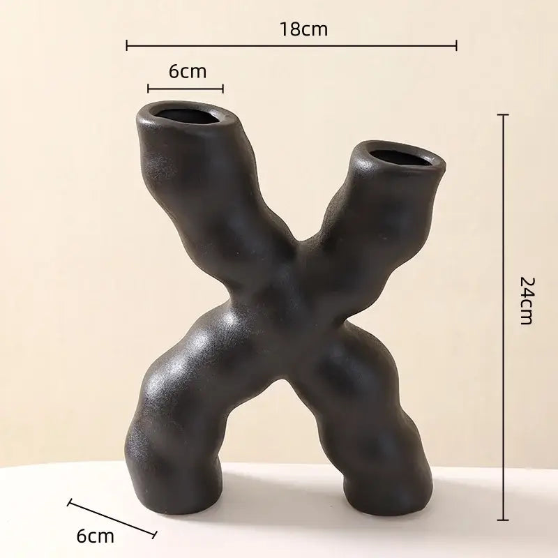 Modern white geometric ceramic flower vase with black sculptural ceramic flower and textured decorbites geometric ceramic design