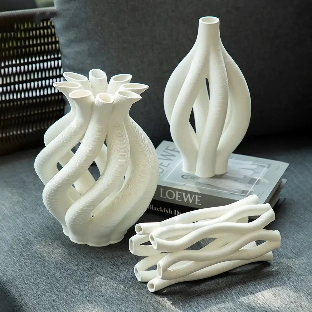 Modern white geometric ceramic hollow vases with intricate twisted design for living room decor by decorbites