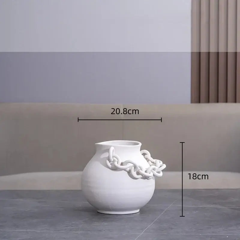 Modern white ceramic vase with sculpted geometric chain detail wrapped around its side for living room decorbites decor