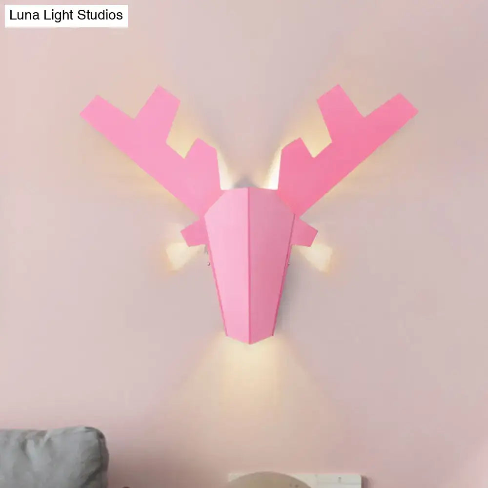 Modern white geometric reindeer wall lamp with pink illuminated antlers designed as a bedroom sconce light
