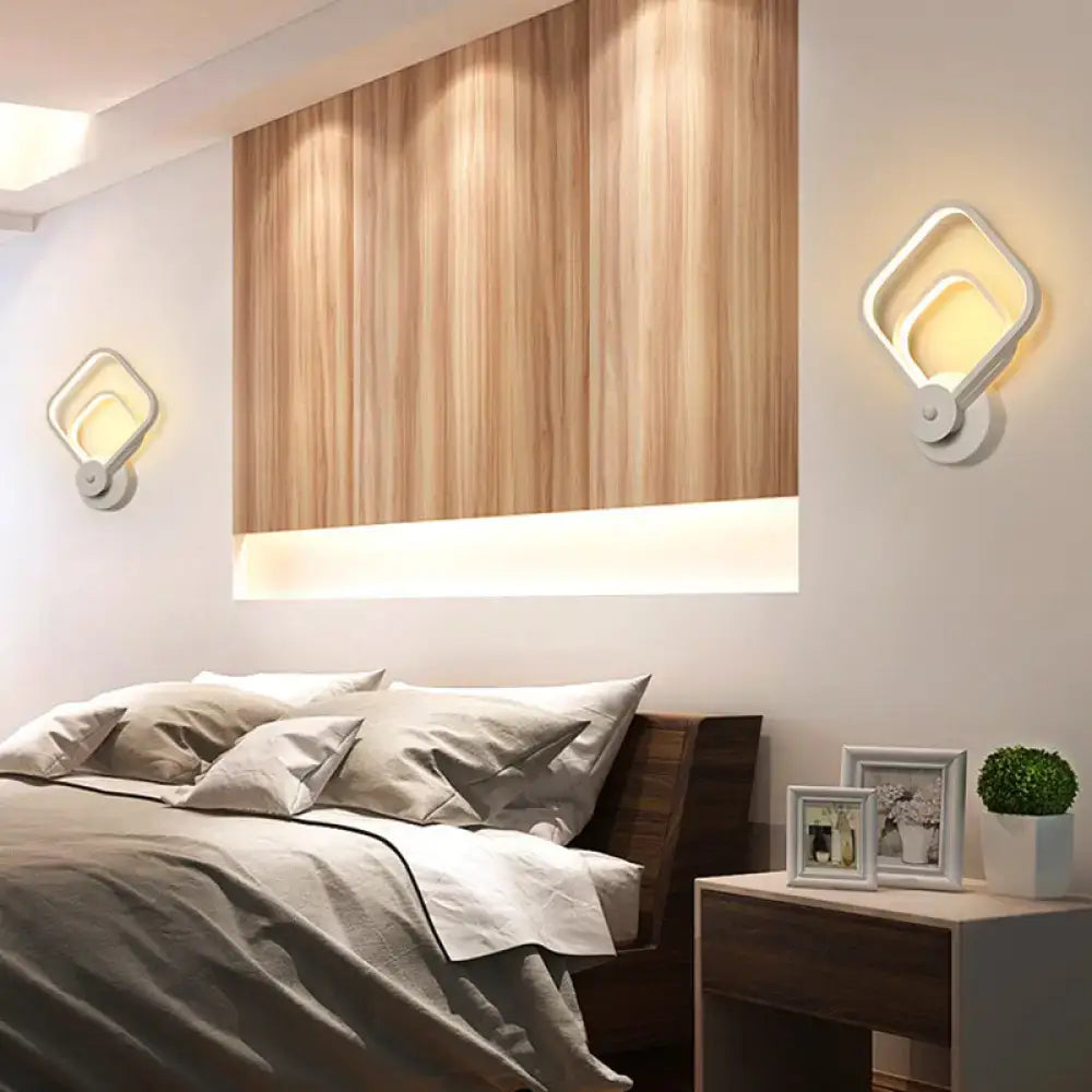 Modern white geometric wall lamp with a twisted design and warm led light ideal for stairway illumination