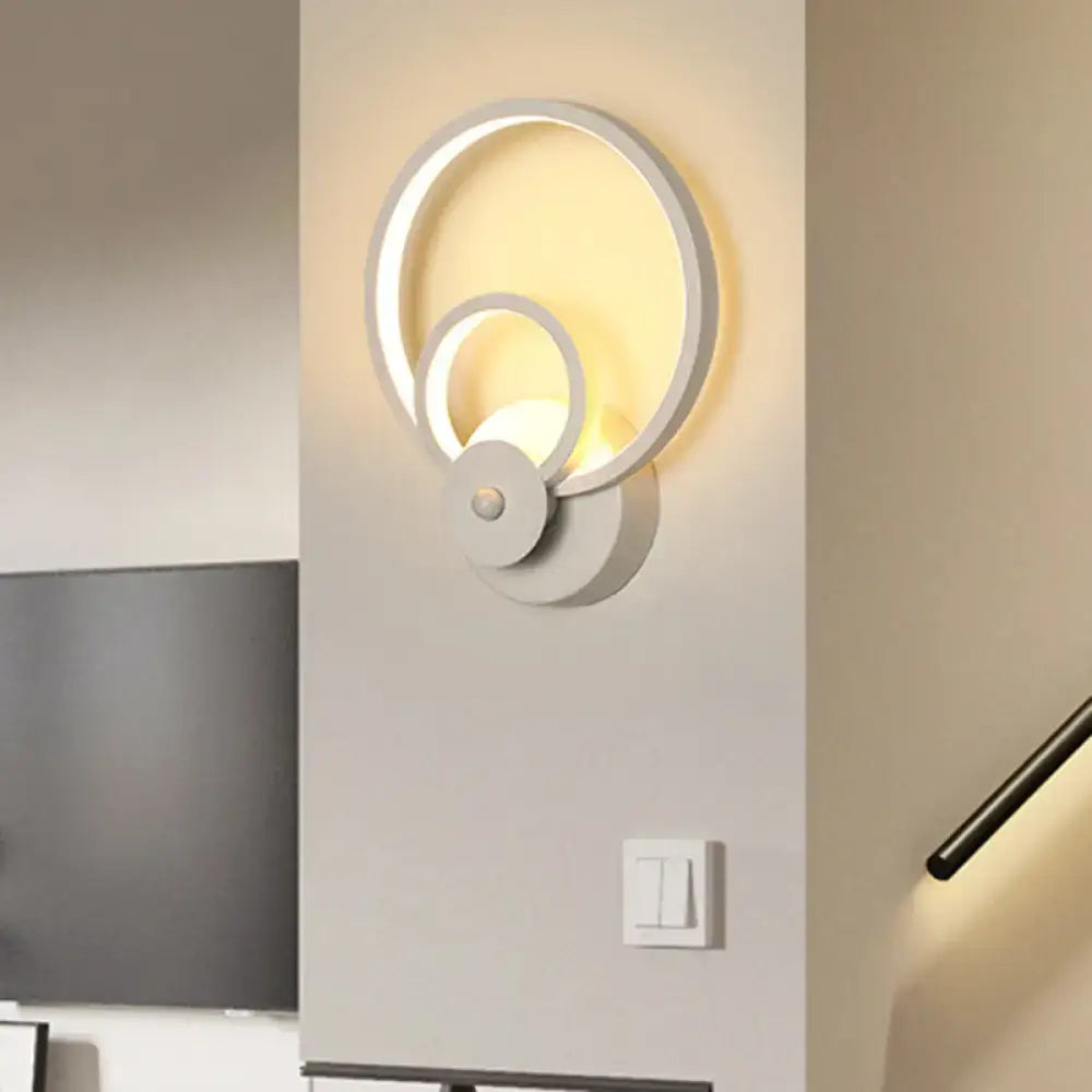 Modern white geometric wall lamp with circular twisted design and warm led lighting for stairway illumination