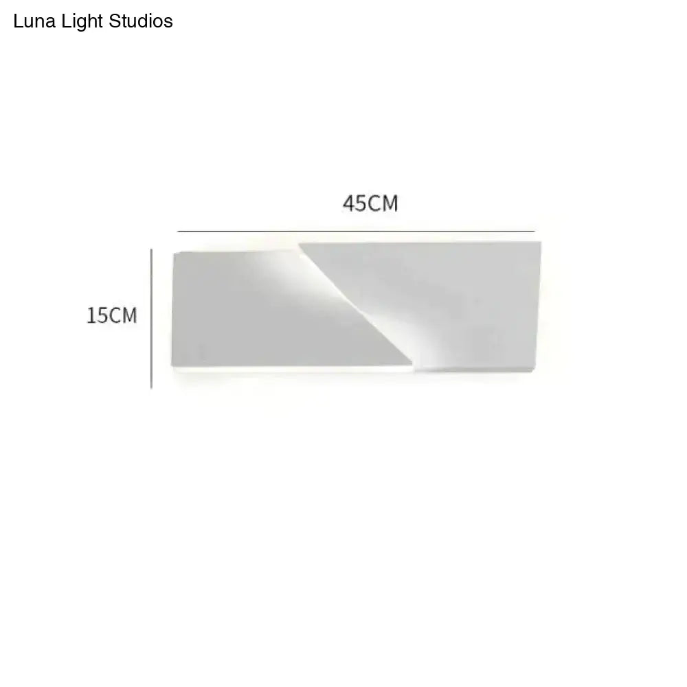 Modern white geometric wall lamp with a sleek matte finish and minimalist rectangular design for living room illumination