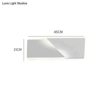 Modern white geometric wall lamp with a sleek matte finish and minimalist rectangular design for living room illumination