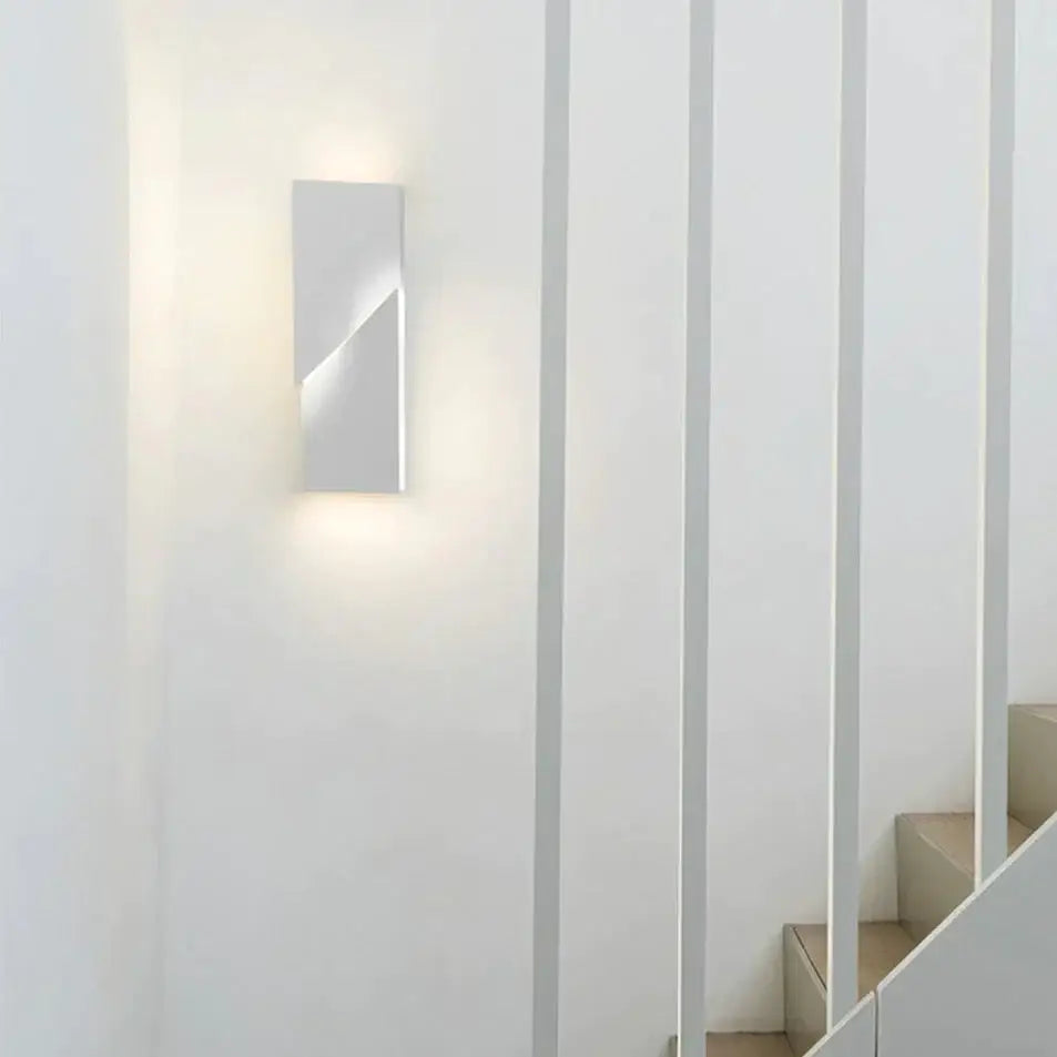 Modern white geometric wall lamp with a sleek rectangular design and smooth finish for living room illumination