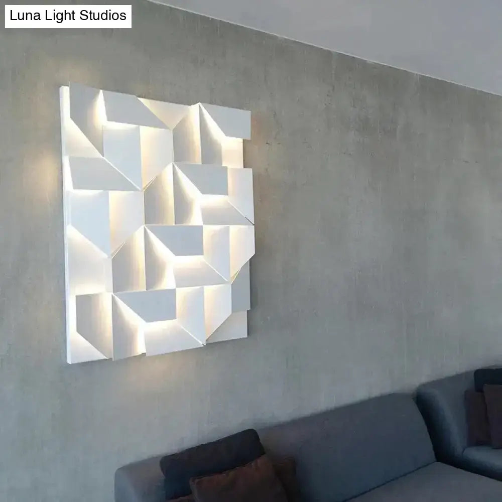 Modern white geometric wall lamp with illuminated facets designed as living room art lighting fixture