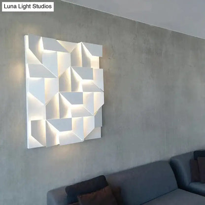 Modern white geometric wall lamp with illuminated facets designed as living room art lighting fixture
