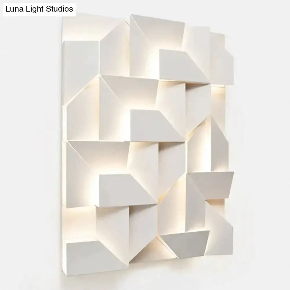 Modern white geometric wall lamp with illuminated angular facets designed for living room lighting and decor