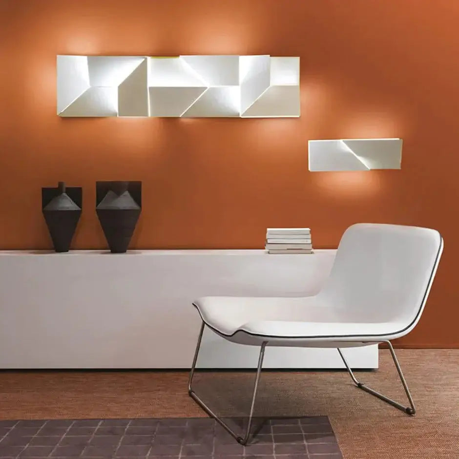 Modern white geometric wall lamp with angular facets and sleek minimalist design for illuminated living room art