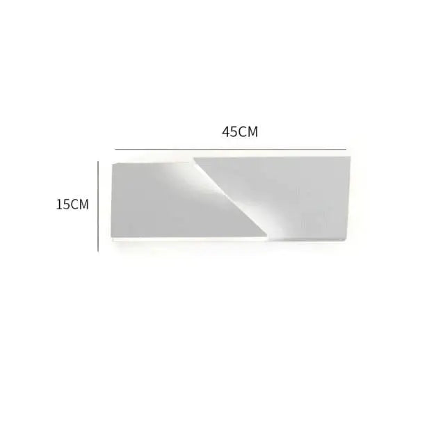 A sleek minimalist rectangular silver mirror with clean geometric edges complements a modern white geometric wall lamp