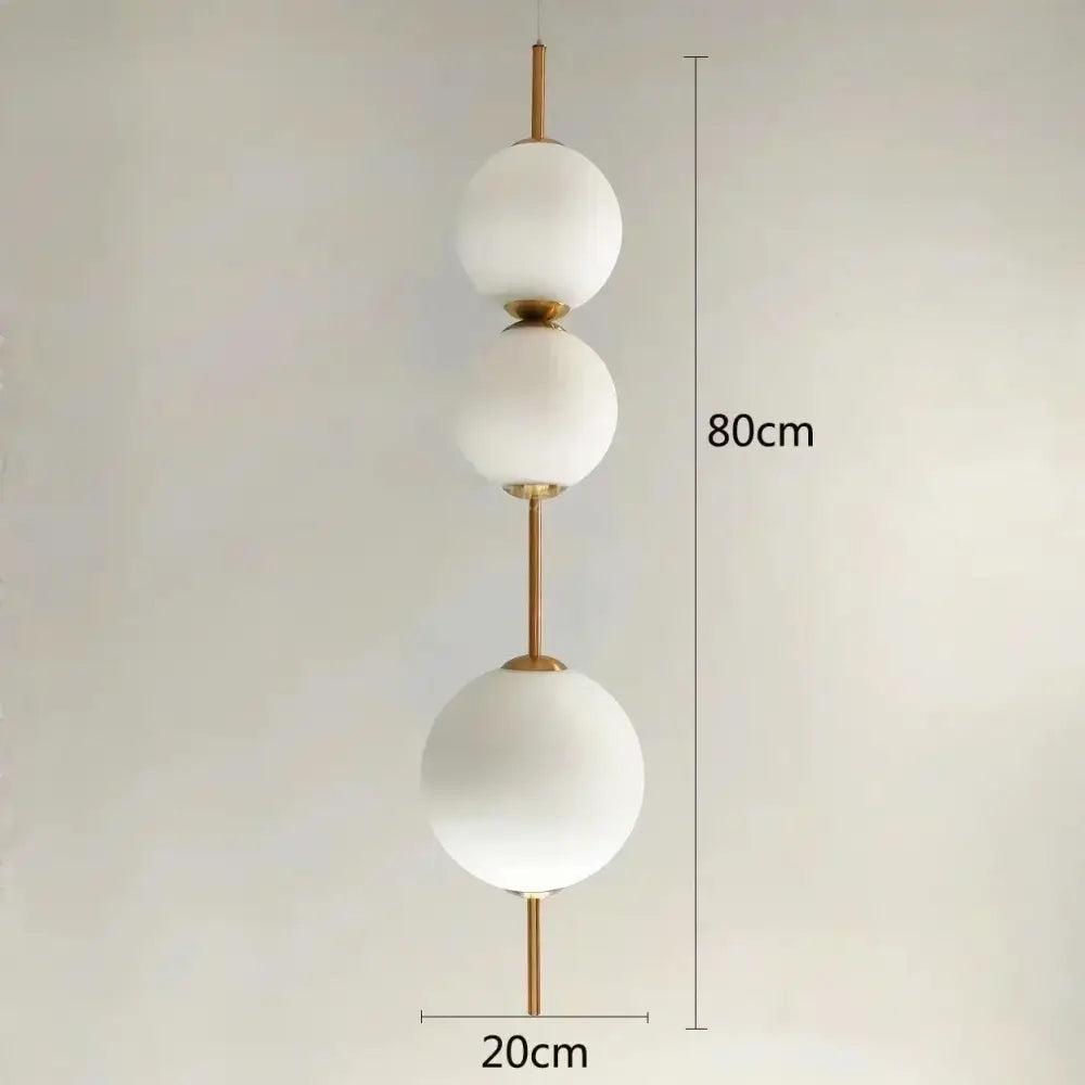 Modern white glass ball led pendant light with frosted spherical shades and polished brass accents for kitchen and dining room decorbites glass ball pendant light