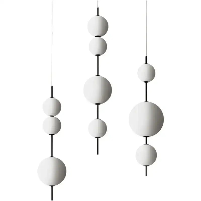 Modern white glass ball led pendant light with black metal connectors by decorbites for kitchen and dining room decor