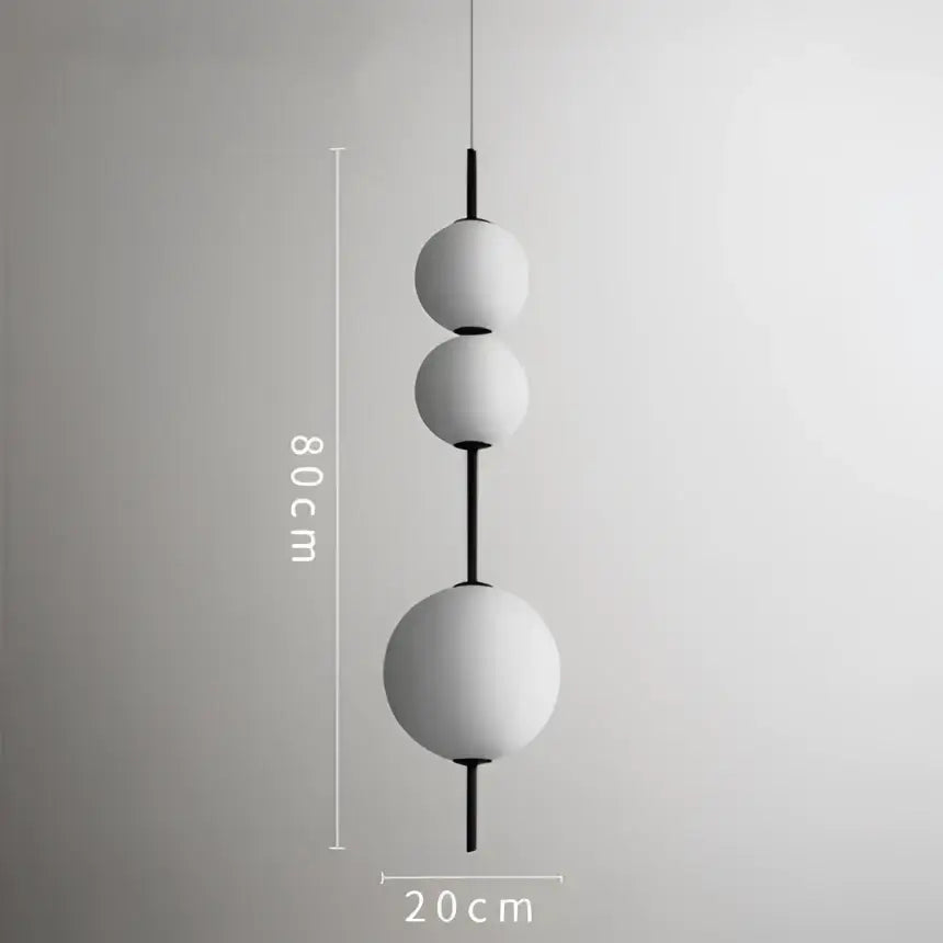 Modern white glass ball led pendant light with black central rods and 80cm length for kitchen and dining room decorbites