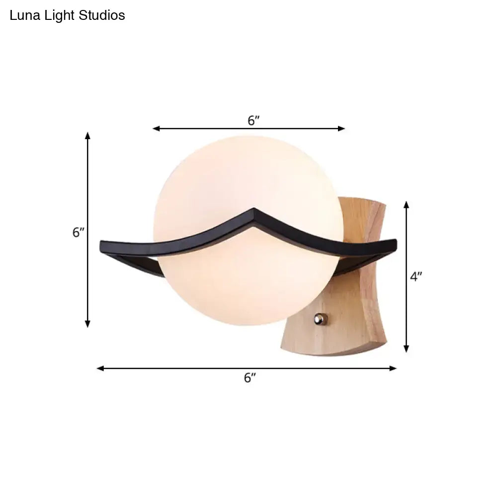 Modern white glass ball sconce with black accent and wood base great addition for bedroom direct wired electric fixture