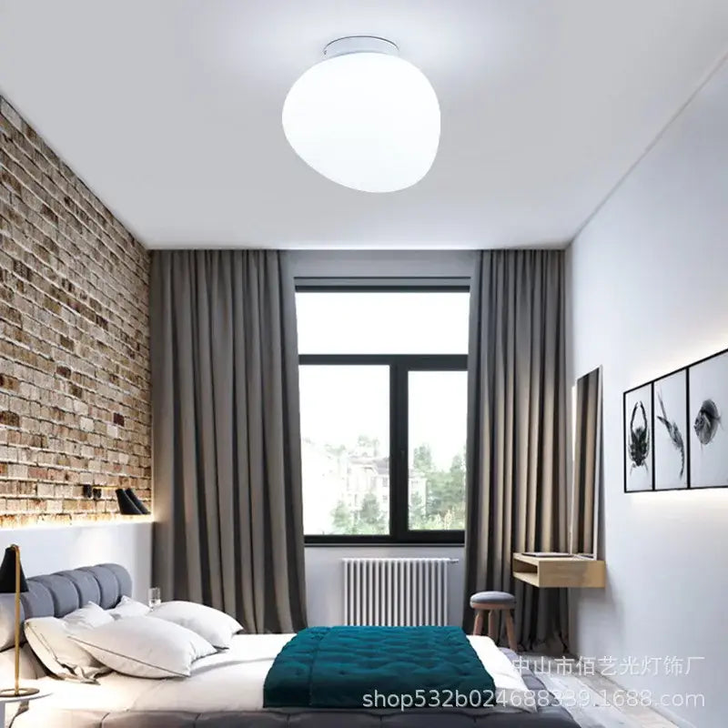 A sleek modern white glass egg wall lamp with a round minimalist design for bedroom wall lamp use