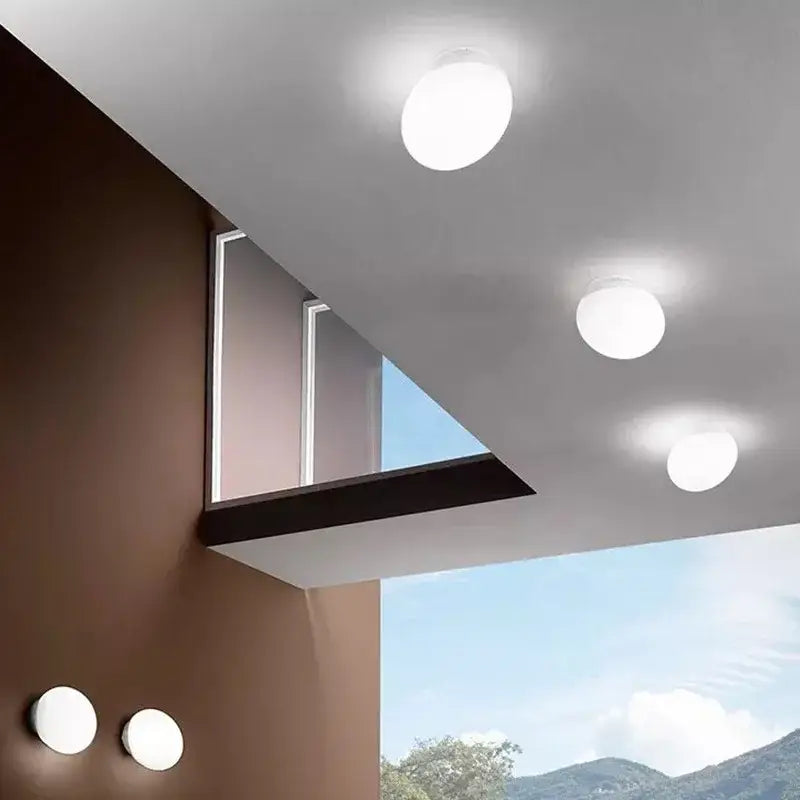 Modern white glass egg wall sconces featuring spherical minimalist ceiling lights as a bedroom wall lamp design