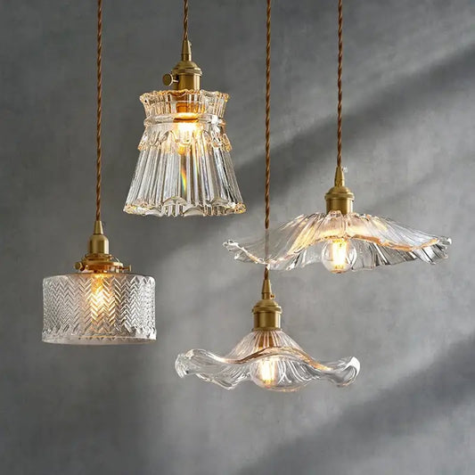 Four elegant white glass pendant lights with fluted shades and brass fixtures create an inviting atmosphere