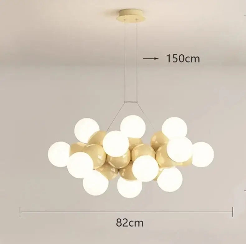 A modern white glass globe pendant light fixture with glossy white and gold spheres for dining room lighting