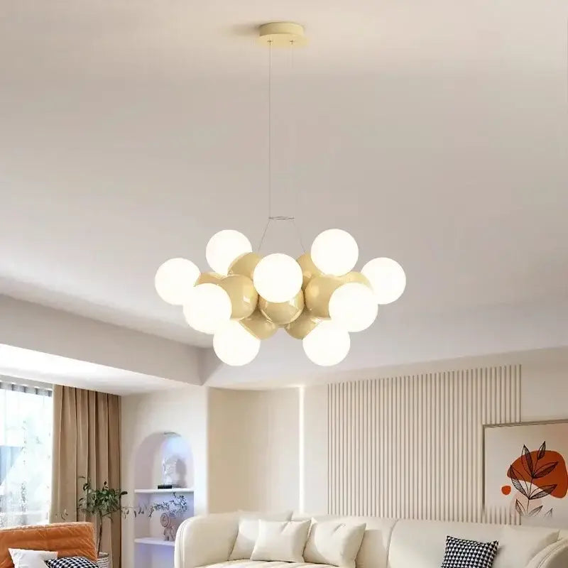 Cream-colored glass globe pendant light fixture with modern cluster design ideal for dining room lighting