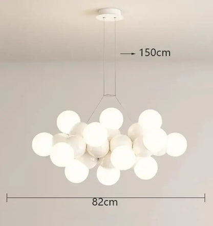 A modern white glass globe pendant light fixture with frosted globes hanging from a minimalist ceiling mount for dining rooms