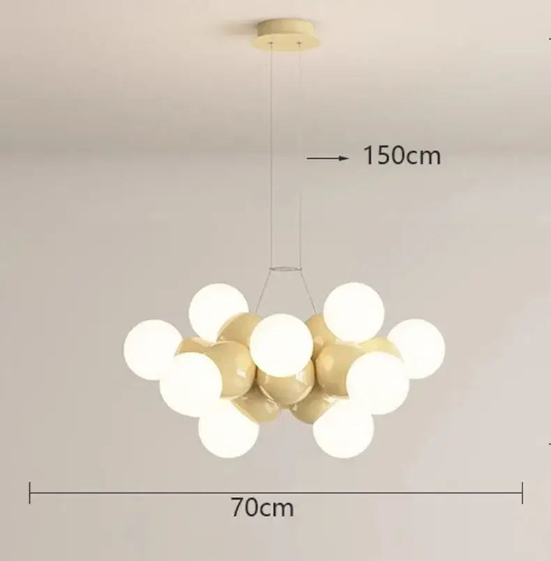 Modern white glass globe pendant light fixture with a cluster of cream and white bulbs and gold-toned ceiling mount