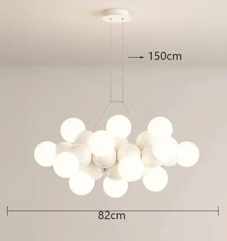 Modern white glass globe pendant light fixture with frosted globes suspended from minimalist ceiling mount