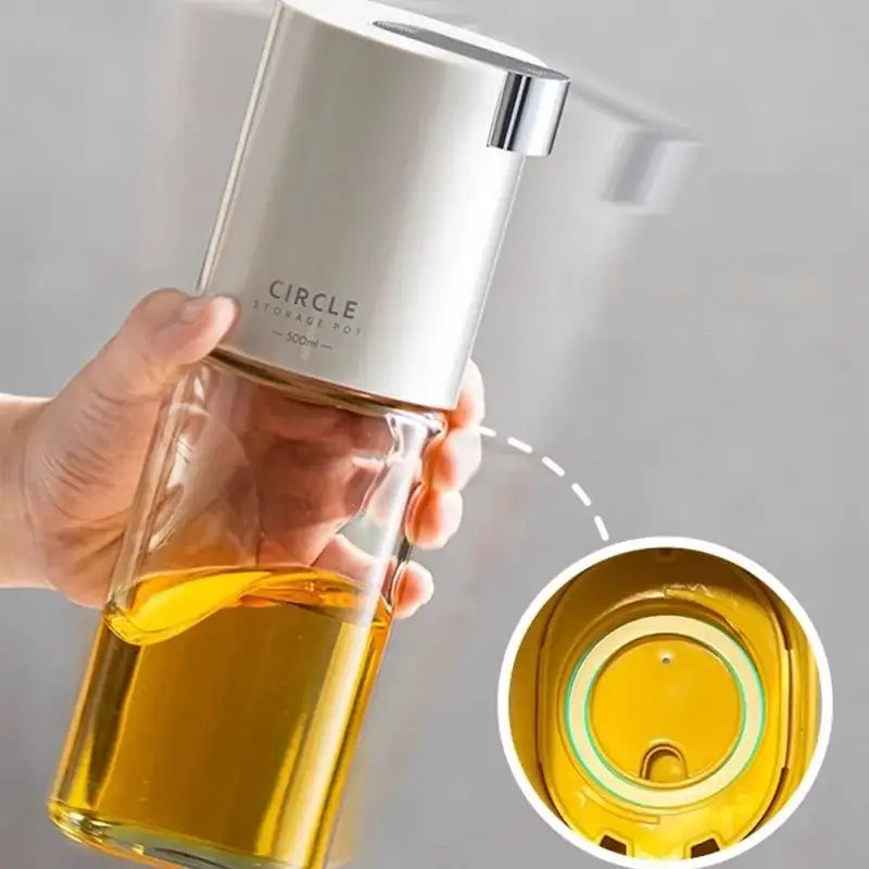 Silver and clear glass oil pot with a sleek modern design from a 4 piece white glass seasoning bottle set
