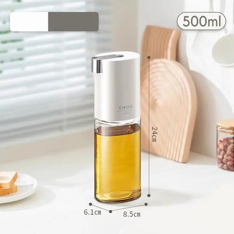 A sleek white and transparent glass oil pot with silver pump top branded circle for use as a seasoning bottle