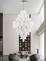 Modern white glass pendant lights featuring a cascading big white glass tube design with gold-toned chain for dining room decorbites big white