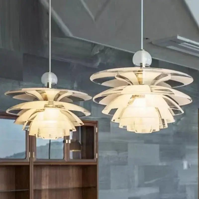 Two elegant modern white glass pine cone pendant lights with layered petals and warm glow for living room chandelier