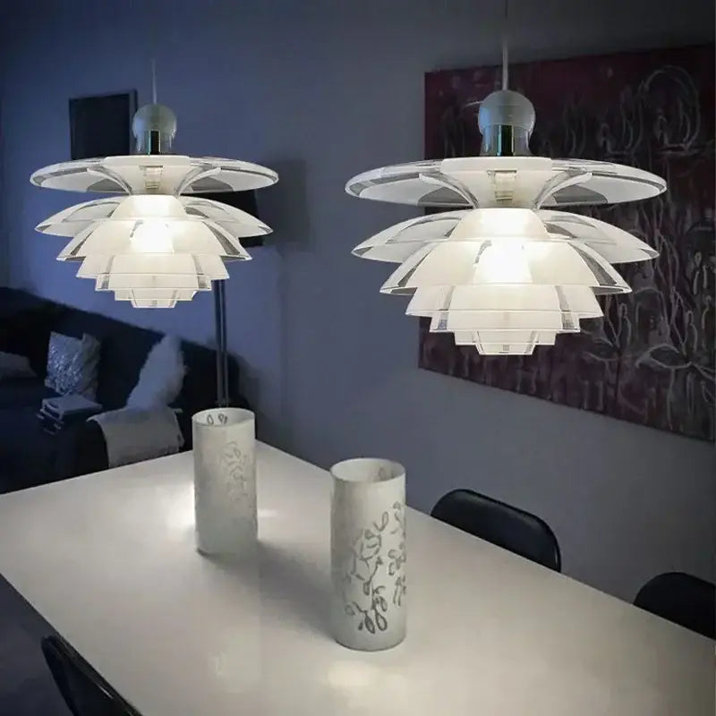 Two white glass pine cone pendant lights with layered petals in a modern cone pendant chandelier for living room