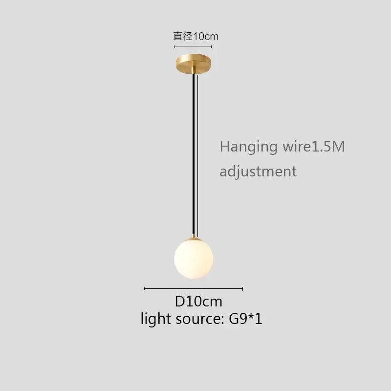 Modern pendant light with gold finish, white globe shade, matte glass globe, and black hanging wire for kitchen and dining room