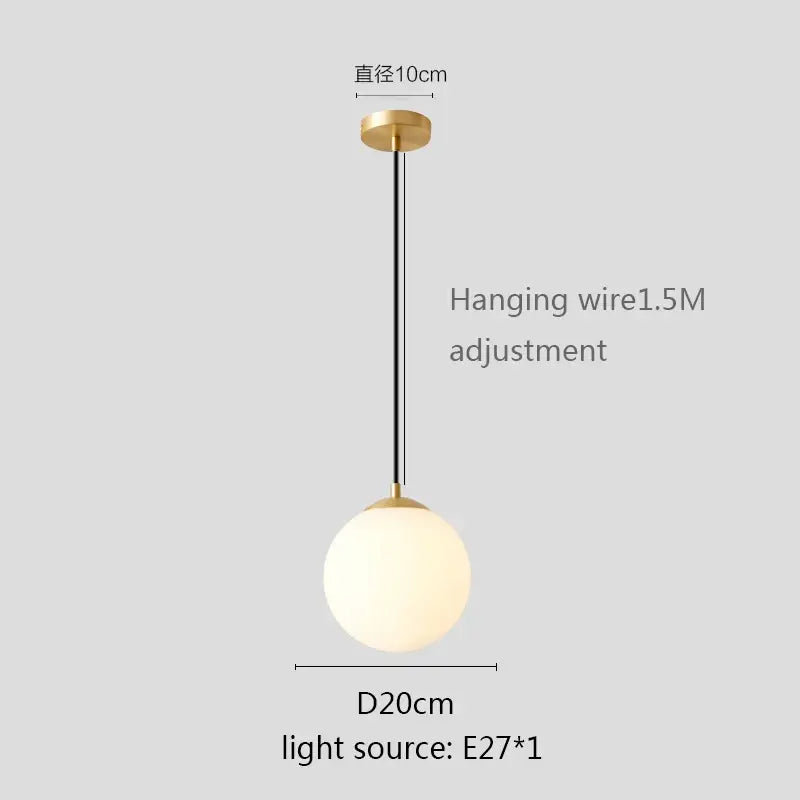 Modern minimalist pendant light with white globe shade frosted glass and gold-toned metal for kitchen dining room