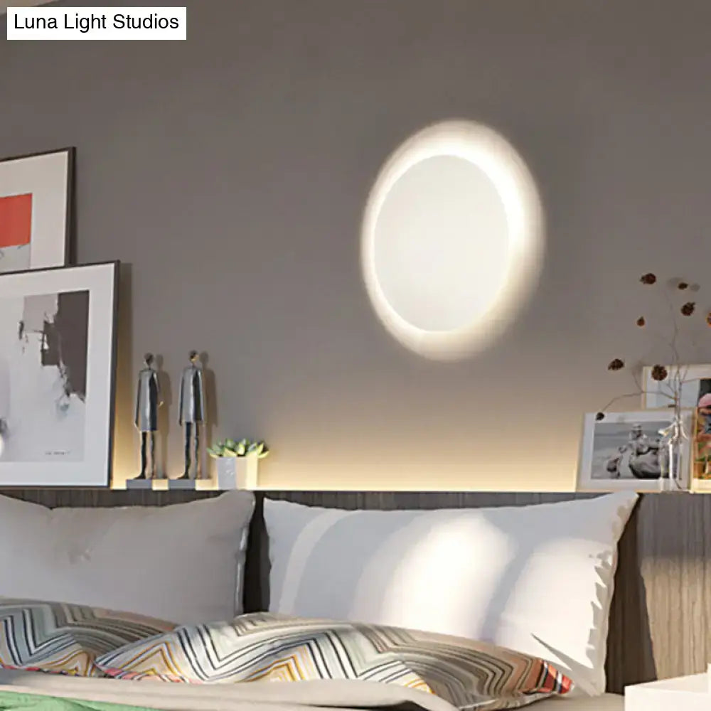 Modern white and gold circular led wall light with warm white glow and minimalist design for bedroom use