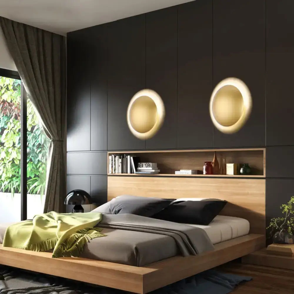 Two warm white white gold circular led wall lights mounted symmetrically above a wooden bedhead in bedroom