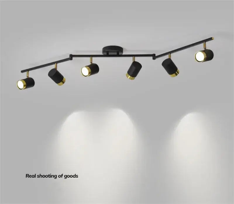 Modern white and gold decorbites ceiling chandelier spotlight with black matte body and polished brass accents