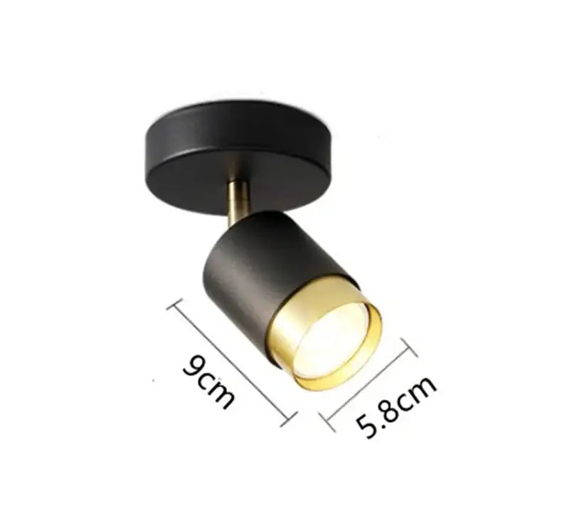 Modern white and gold decorbites ceiling chandelier with black and brass accent spotlight and sleek cylindrical design