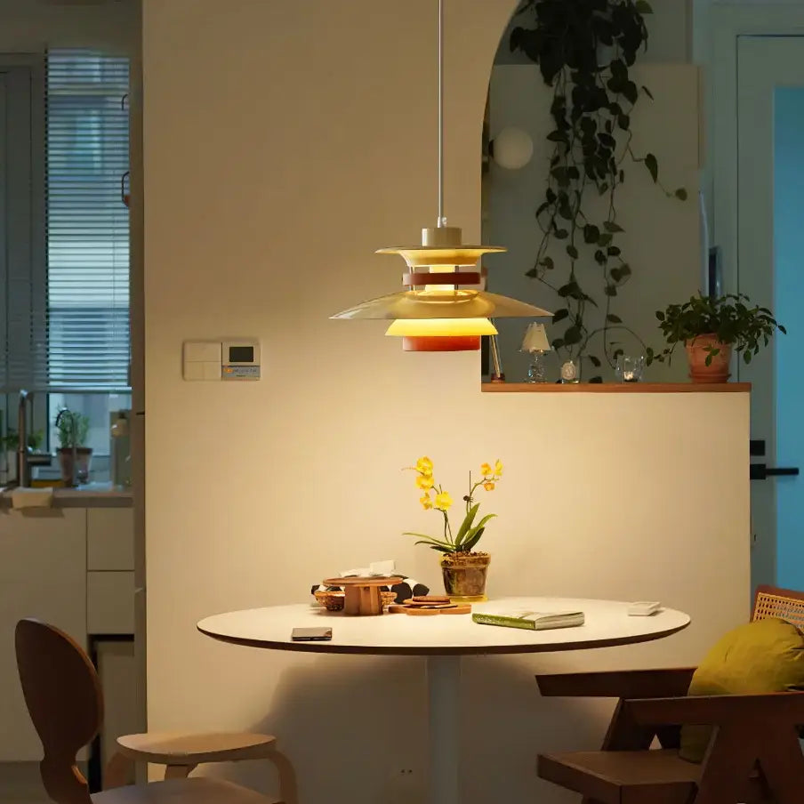 A modern white and gold decorbites designer pendant light with layered yellow and red tones for living room decor