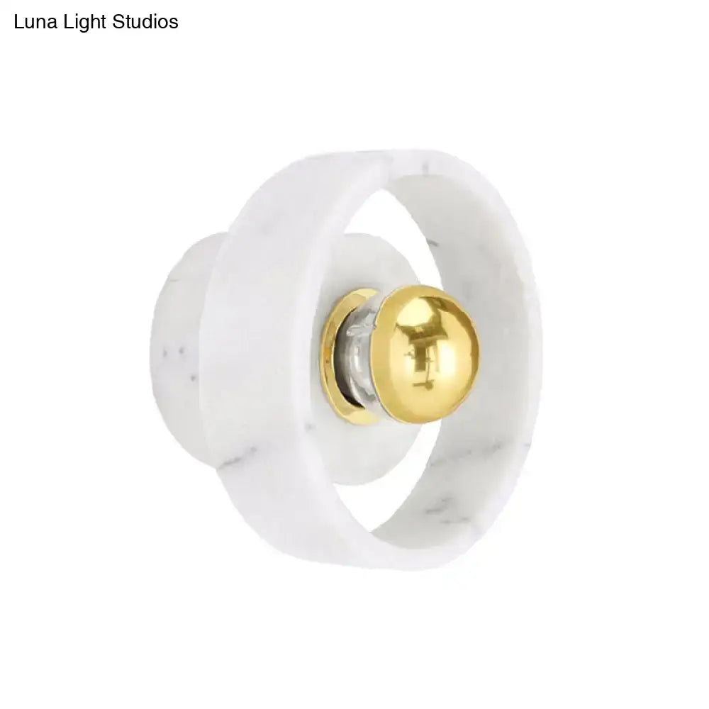 Modern white marble designer wall sconce with polished gold spherical accent ideal for bedroom lighting