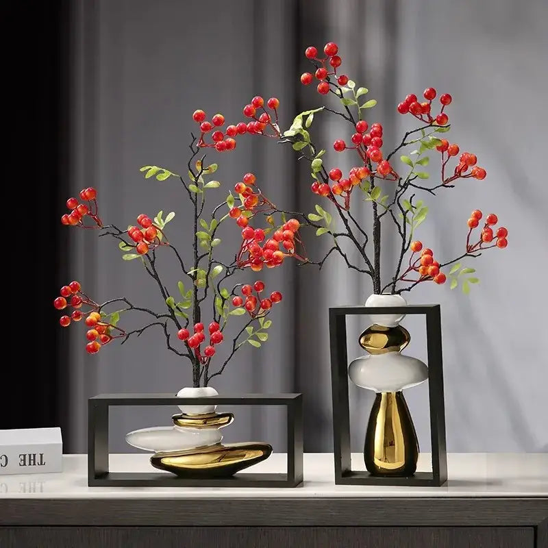 Two modern ceramic vases with white and gold geometric golden rockery design holding artificial red berries for decorbites geometric golden decor